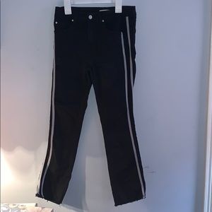 Black flared pants with white stripes on side